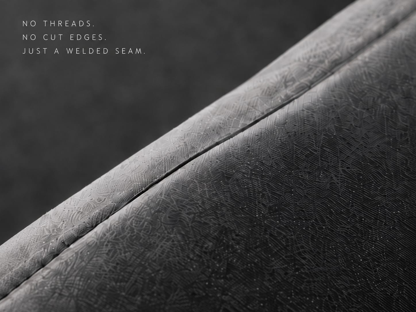 Macro of the shoulder seam: no threads, no cut edges, just a welded ridge of fused material